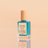 bottle of bkind nail polish in a teal color