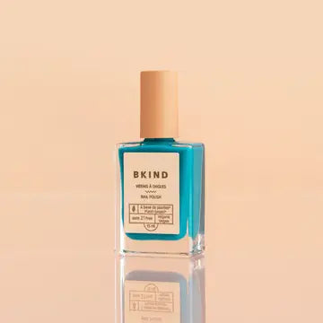 bottle of bkind nail polish in a teal color
