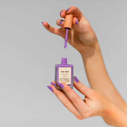 bkind nail polish in purple held by white hands