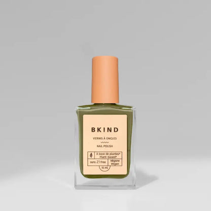 A bottle of BKind Nail Polish by BKind, featuring a peach cap and light peach label with green polish inside, is shown against a plain gray background.