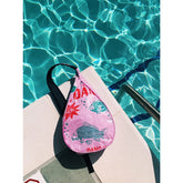 Pink bag with fish design on a poolside background