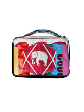 The Cement6 Lunch Box is a colorful, rectangular insulated bag with a handle, showcasing a white elephant inside a red diamond on the front and decorated with multicolored patterns and text.