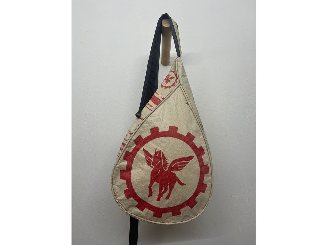 Beige bag with red emblem featuring a winged horse on a white background