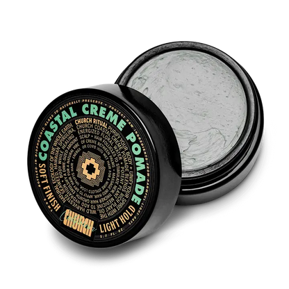 An open black container of Curch California Cream Pomade - Light Hold reveals light gray cream inside. The label features Soft Finish and Light Hold in green, gold, and white, centered by a cross logo.