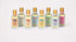 dip hair and body dry oil in a clear bottle with gold lid line up of all scents