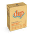 A beige Dip Body Wash Bar labeled "drp" in orange and white features “Coconut + Almond BODY WASH Cleansing Soap Bar.” This eco-friendly Dip product displays weight and vegan, cruelty-free symbols.