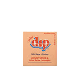 The peach mini dip box holds a 0.75 oz (21 g) Dip Conditioner Bar by Dip, suitable for all hair types. It detangles, offers UV protection, and works as a conditioner and after-swim detangler.