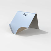 A minimalist silver Life Preserver Draining Soap Dish by Dip, featuring a folded design and small logo on top, set against a light background—eco-friendly and durable for any space.