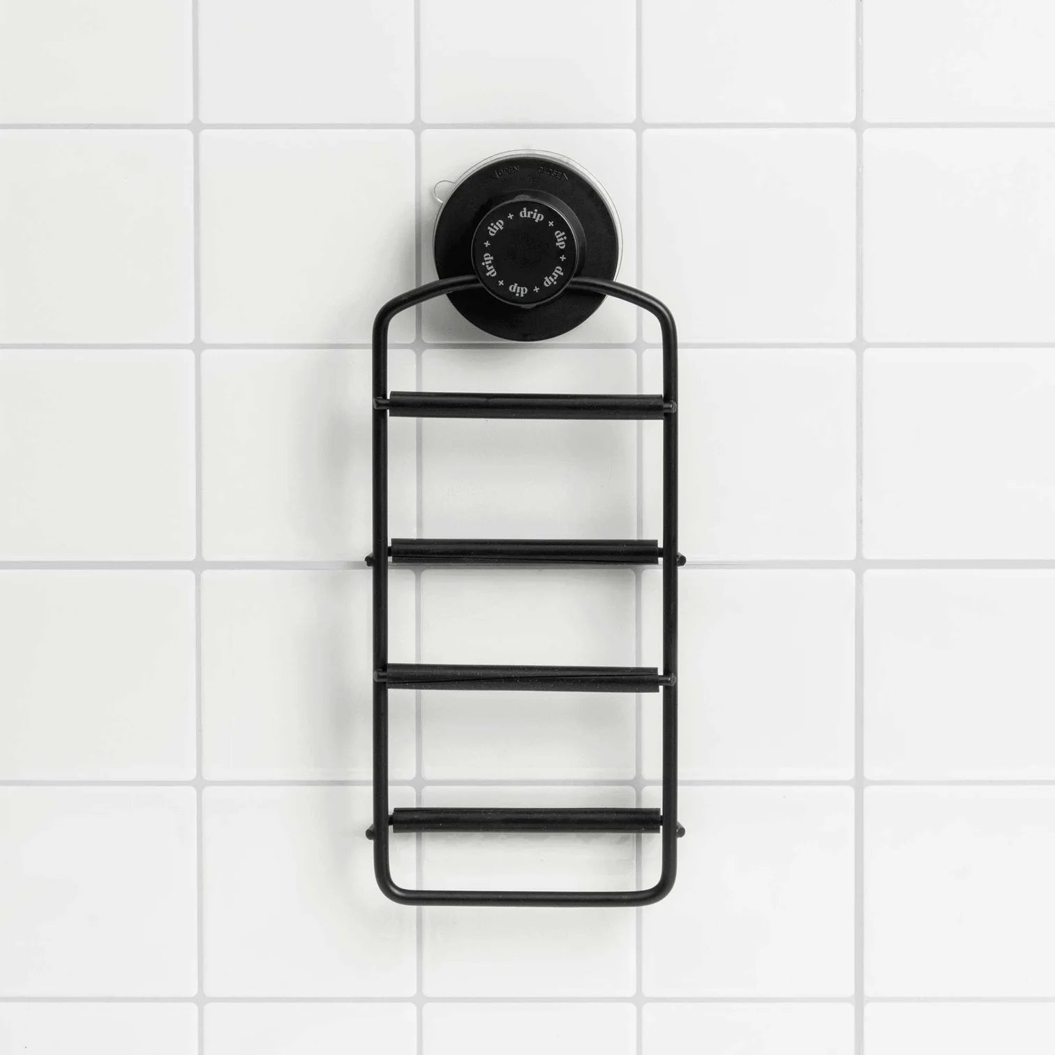 The Dip &amp; Drip Wall Mount Adapter by Dip is secured to a white tiled wall using a large round twist-lock suction cup, providing stable attachment for accessories on non-porous surfaces.