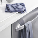 stainless steel cleaning cloth hanging from dishwasher