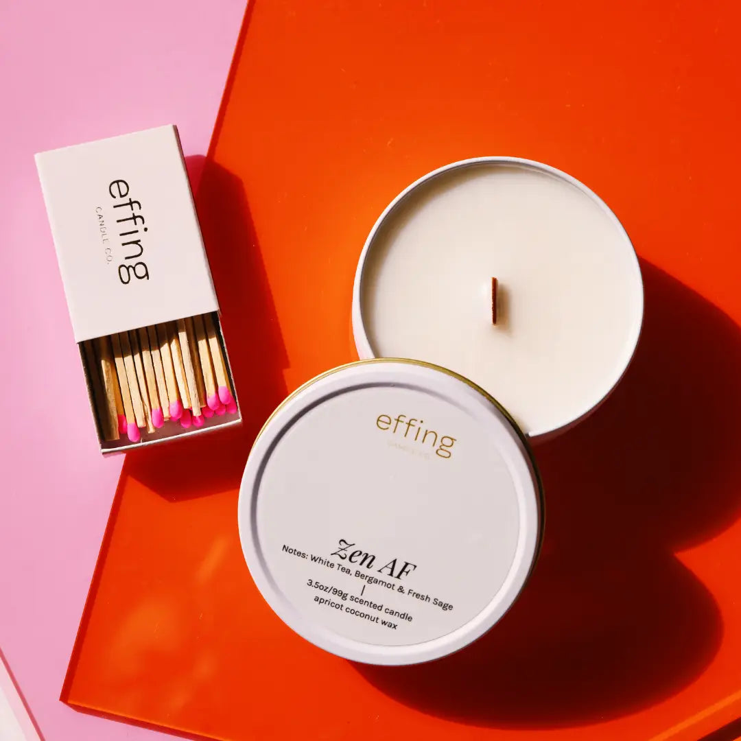 Candle with matches on a pink and orange background