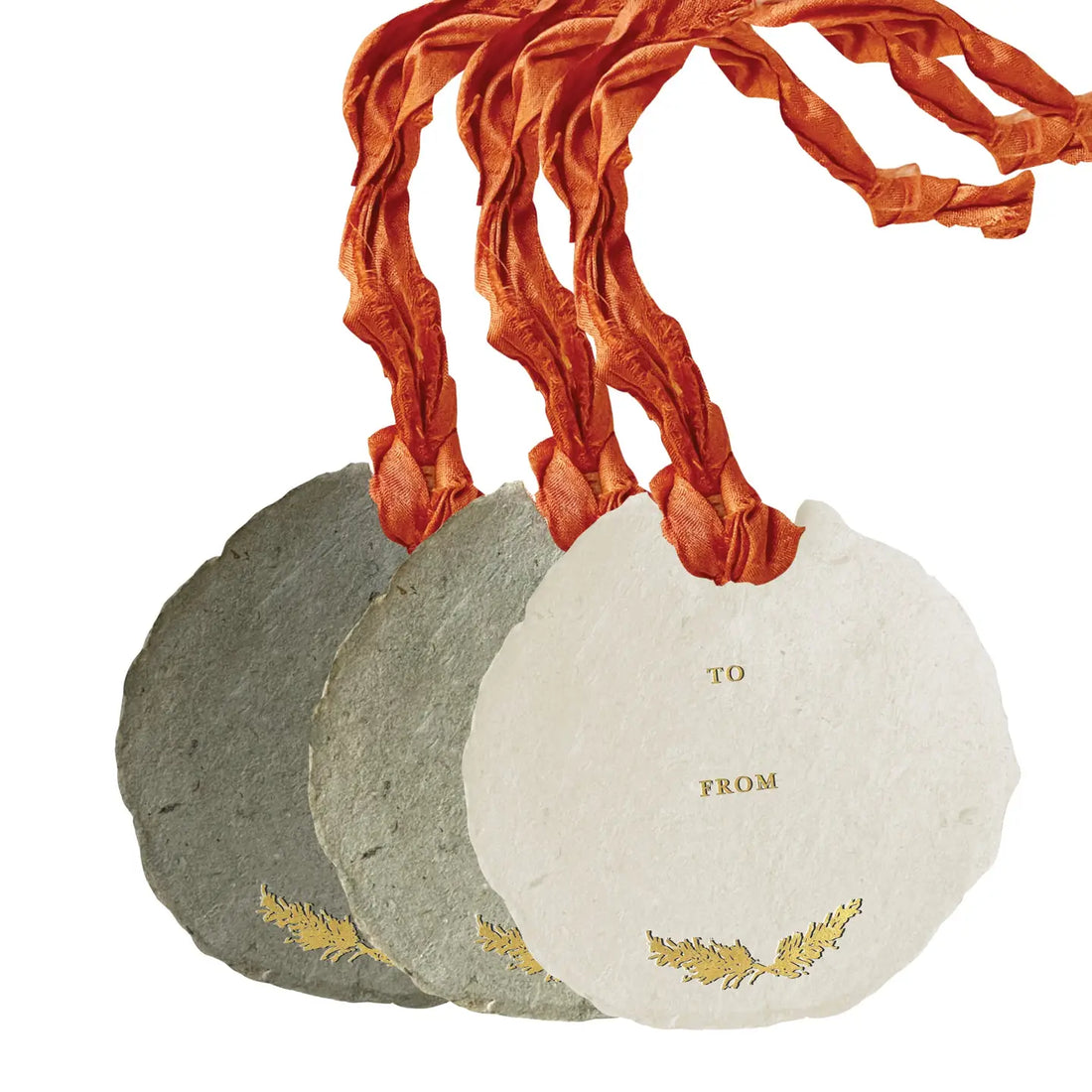 Three stone-like gift bags with gold leaf designs and red ribbon on a white background