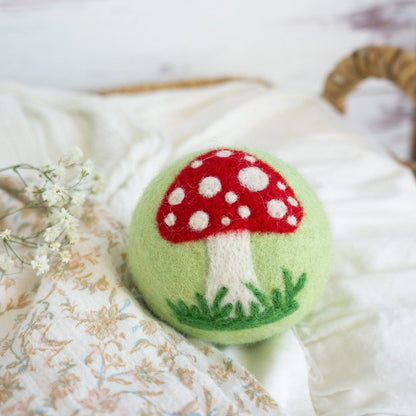 green wool dryer ball with mushroom