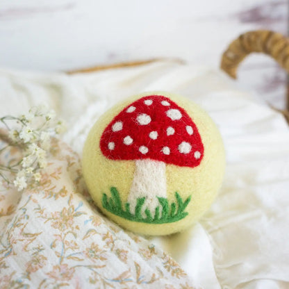yellow wool dryer ball with mushroom