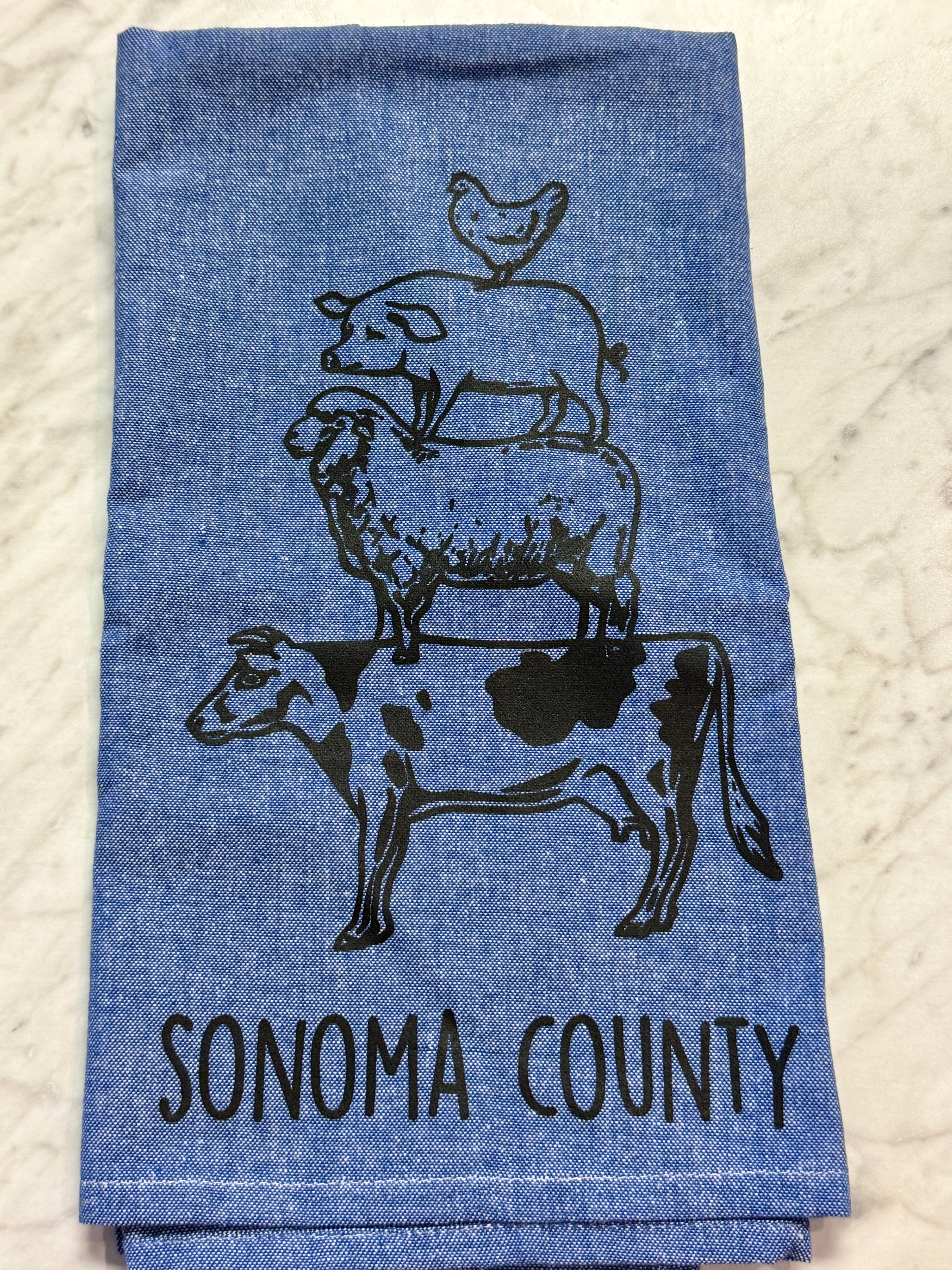 Blue towel with animal illustrations and &