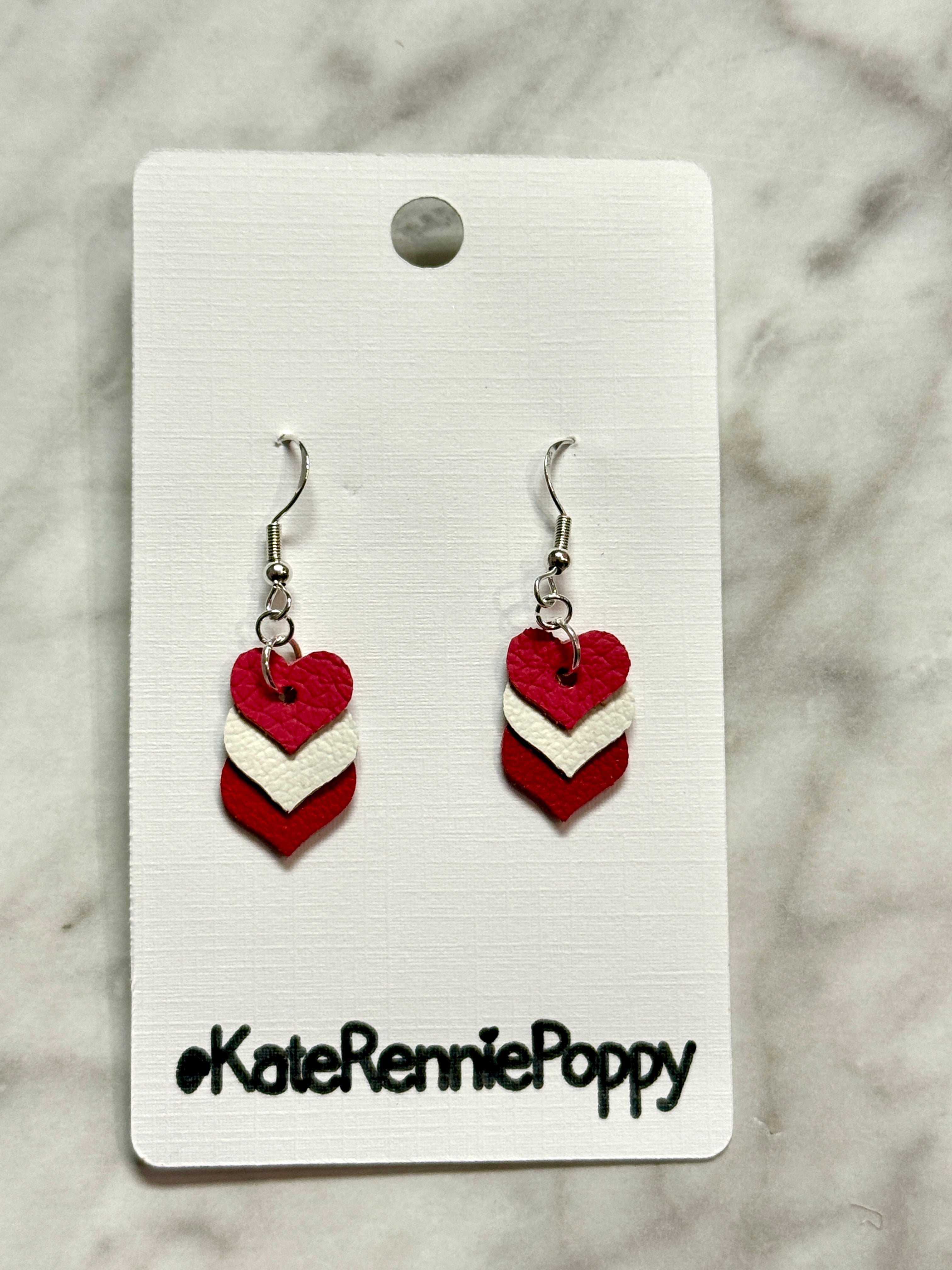 Heart-shaped earrings on a card with &