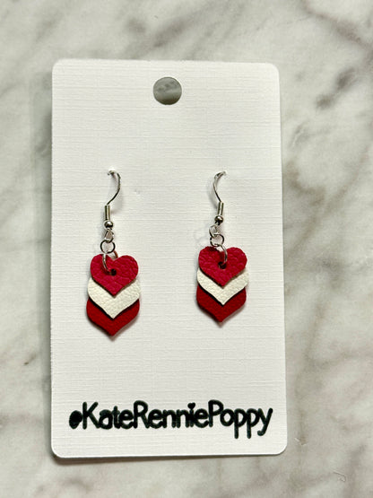Heart-shaped earrings on a card with &