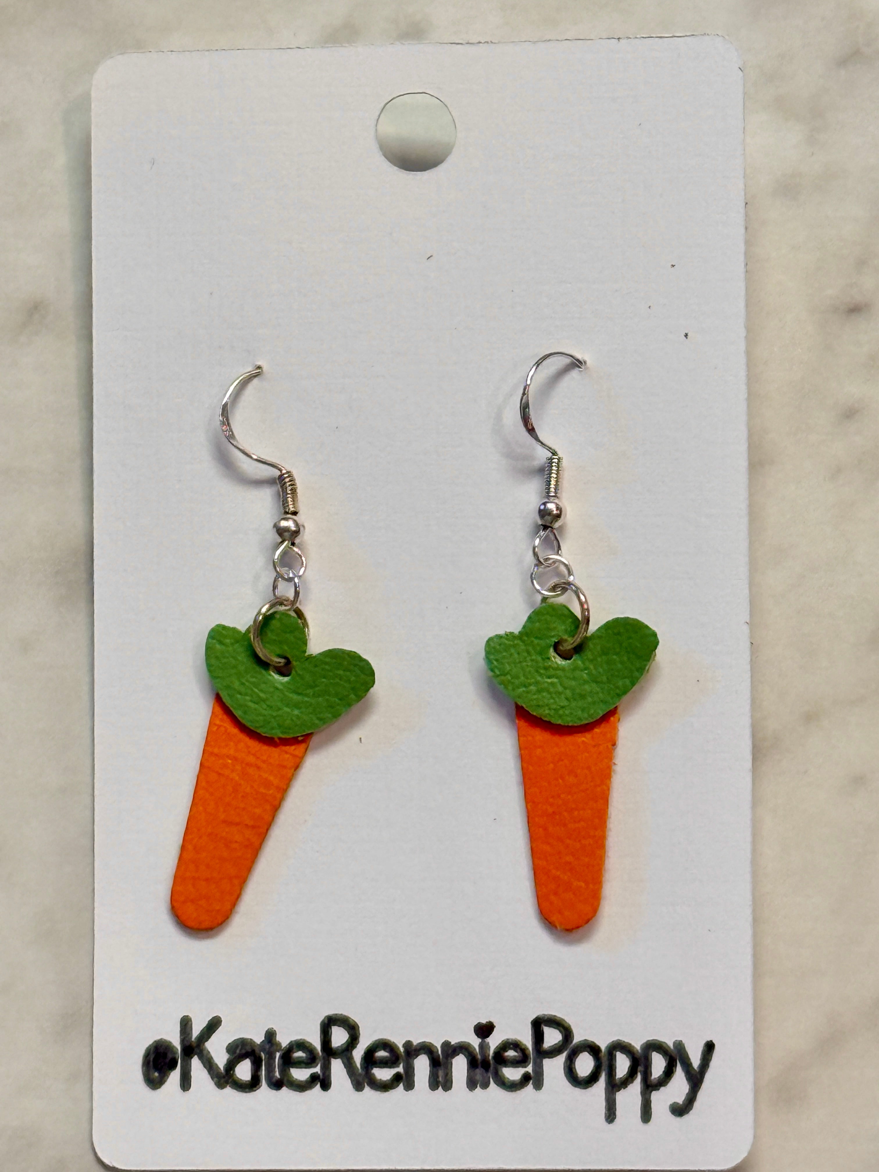 Carrot-shaped earrings on a card with &