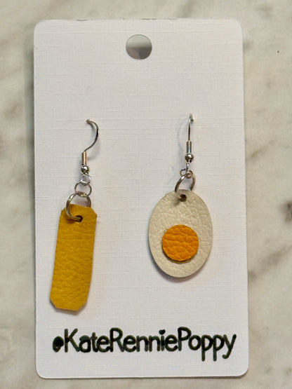 Pair of butter and egg earrings on a card with &