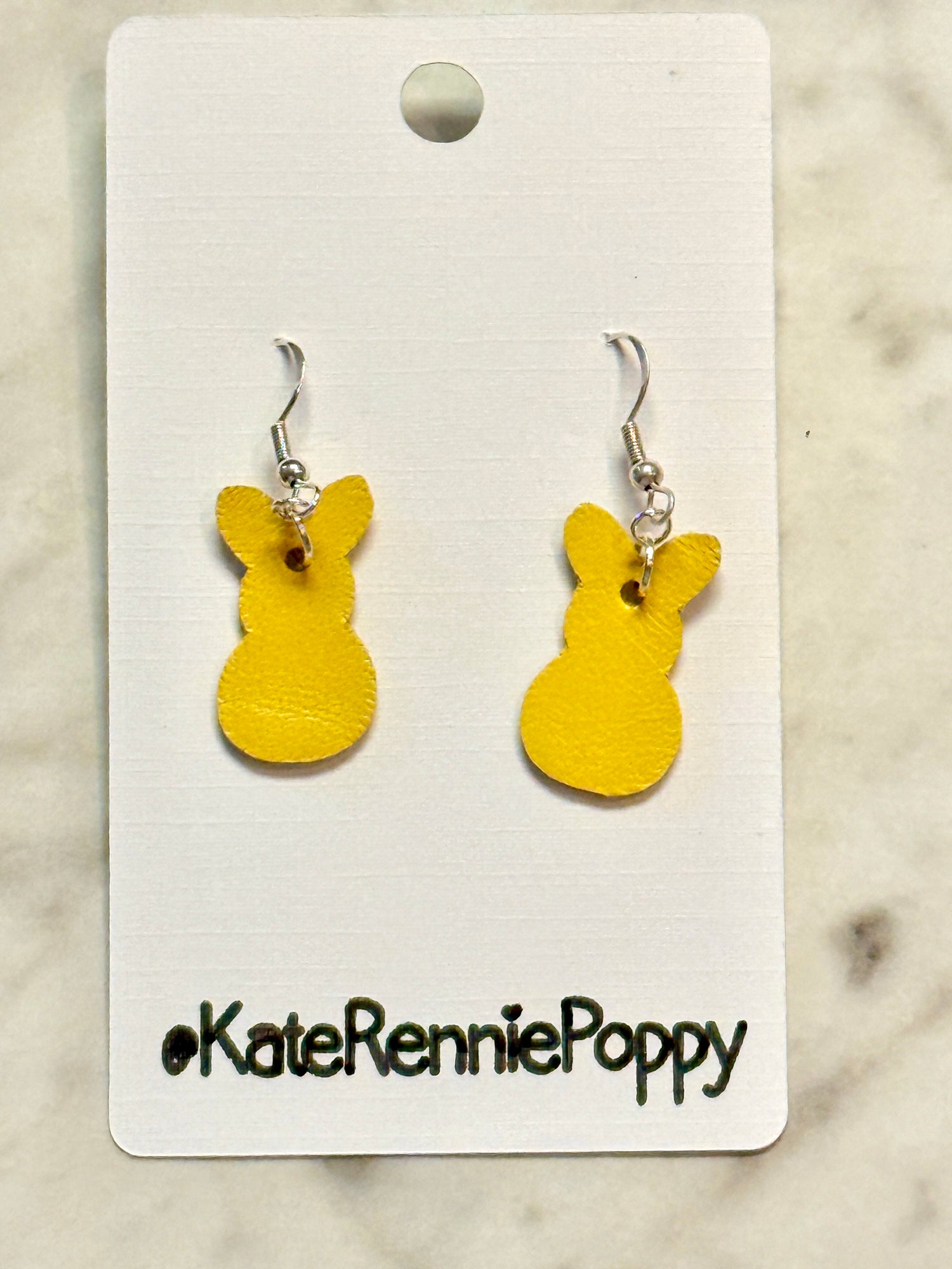 Yellow bunny-shaped earrings on a &
