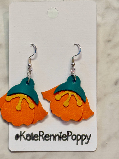 Orange and teal earrings on a &