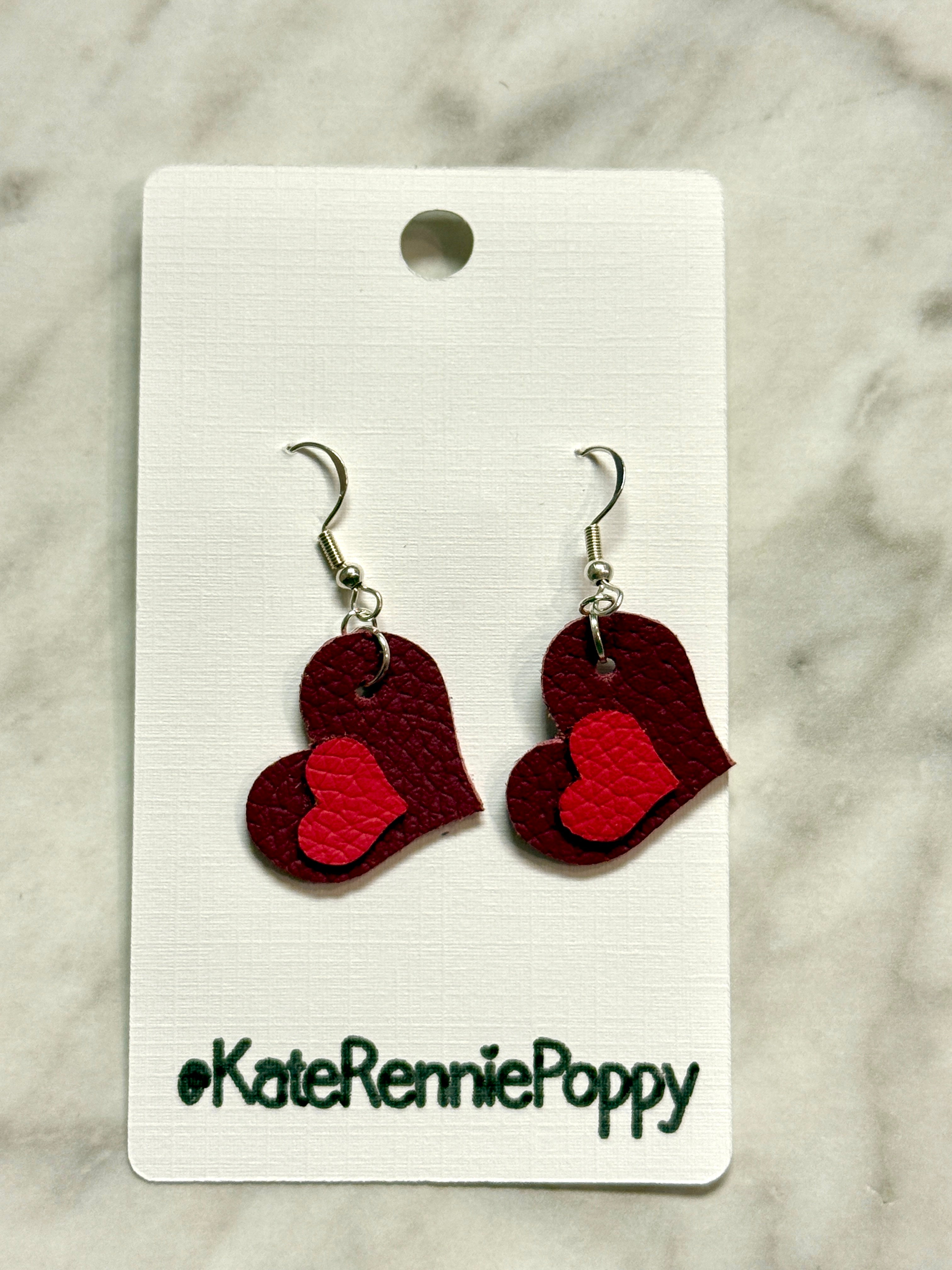 Heart-shaped earrings on a card with &