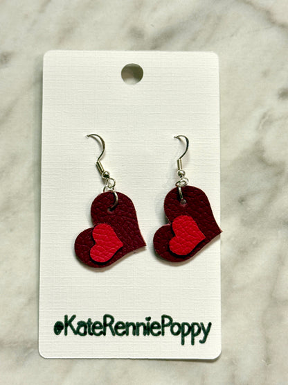 Heart-shaped earrings on a card with &