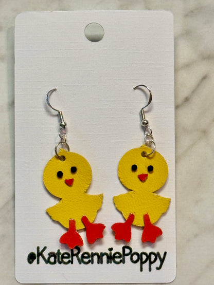 Yellow chick-shaped earrings on a card with &