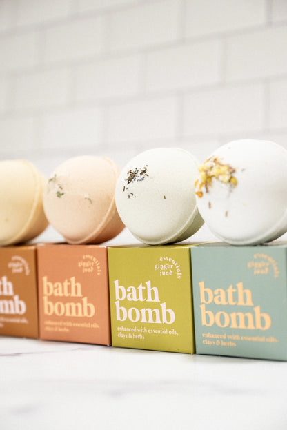 Four bath bombs with visible packaging on a light background