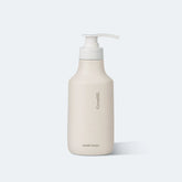 Beige hand wash bottle with pump on a white background
