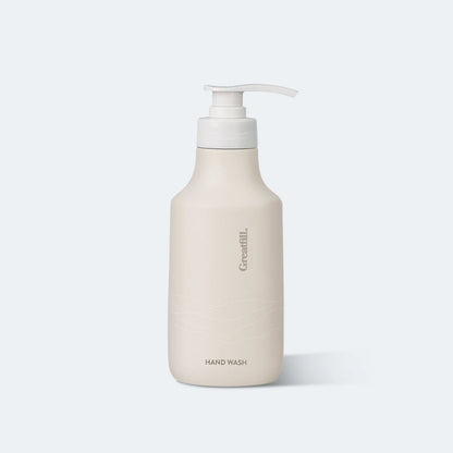 Beige hand wash bottle with pump on a white background
