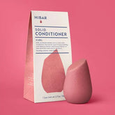 Pink solid hibar conditioner bar with packaging on a pink background