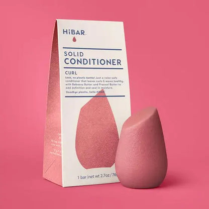 Pink solid hibar conditioner bar with packaging on a pink background