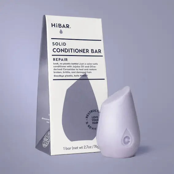 Solid conditioner bar with packaging on a gray background
