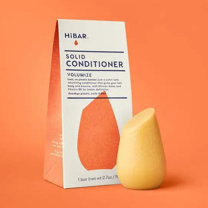 Solid conditioner bar and packaging on an orange background