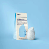 Solid shampoo bar with packaging on a blue background