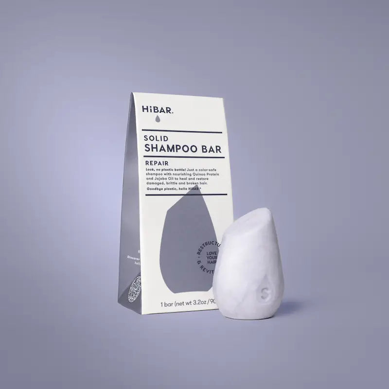 Solid shampoo bar with packaging on a gray background