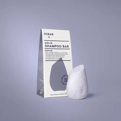 Solid shampoo bar with packaging on a gray background
