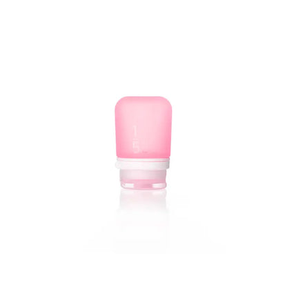 The Humangear GoToob+ is a small, translucent pink silicone travel bottle with a white screw-on cap—ideal as a refillable toiletry container for hassle-free trips.
