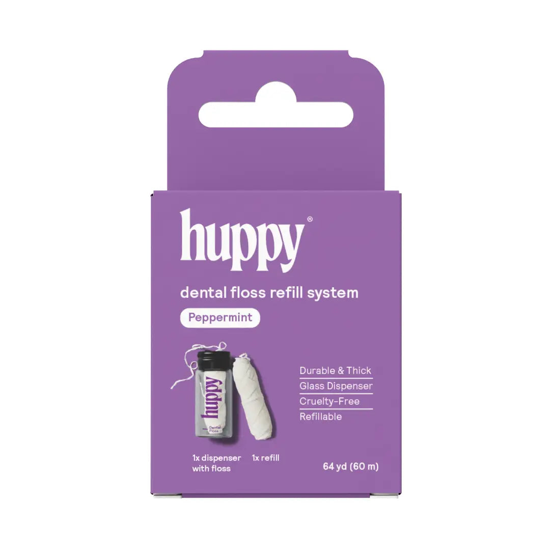 Huppy Vegan Floss in Peppermint, packaged in a purple box, features a glass dispenser with floss and a refill. Highlights include durable, cruelty-free, refillable, and plastic-free floss; contains 64 yd (60 m) per package.