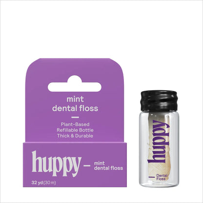Huppy mint dental floss packaging with a clear bottle on a white background