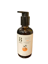 A dark brown pump bottle labeled 8 Days Botanicals Body Oil, Joy scent with grapefruit and neroli, displays two oranges on the front. This 6 fl oz (177 ml) body oil provides aromatherapy benefits.
