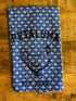 blue with a white cross design a tea towel with Petaluma and a chicken printed