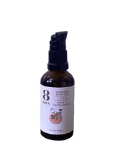 A 2 fl oz (59 ml) brown bottle of 8 Days Botanicals Body Oil in the "Love" scent, with rose and sandalwood, features a floral pink label, black pump dispenser, and offers aromatherapy benefits.