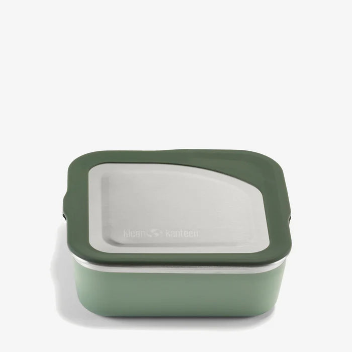 The Klean Kanteen Stainless Steel Lunch Box 23 oz is a square, green reusable food container with a stainless steel lid and dark green silicone trim, designed to be leakproof and shown against a plain white background.