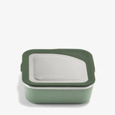The Klean Kanteen Stainless Steel Lunch Box 23 oz is a square, green reusable food container with a stainless steel lid and dark green silicone trim, designed to be leakproof and shown against a plain white background.
