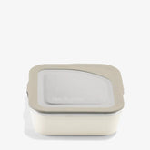 The Klean Kanteen Stainless Steel Lunch Box 23 oz features a square, cream-colored body with a light gray lid and clear top window, displayed against a white background.