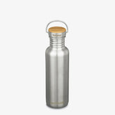 A minimalist, plastic-free Klean Kanteen Stainless Steel Water Bottle - 27 oz with a wooden cap and metal handle stands upright on a plain white background, showing the brand name near the bottom and on the lid.