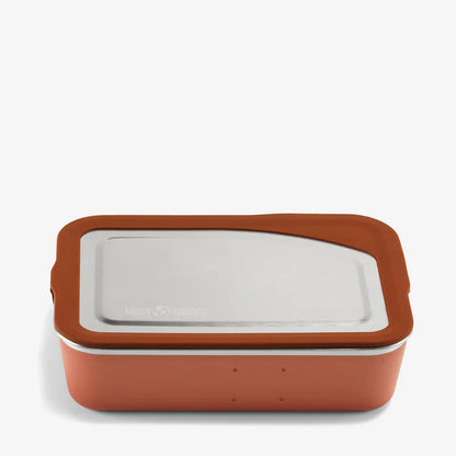 The Klean Kanteen Stainless Steel Lunch Box 34 oz features a rectangular, leakproof design with an orange silicone base for sustainable food storage, shown against a plain white background.