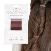 mini natural kooshoo rubber bands next to head with long brown hair